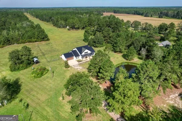a backyard of a house with yard and outdoor seating