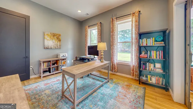 a living room with furniture a bookshelf and a window