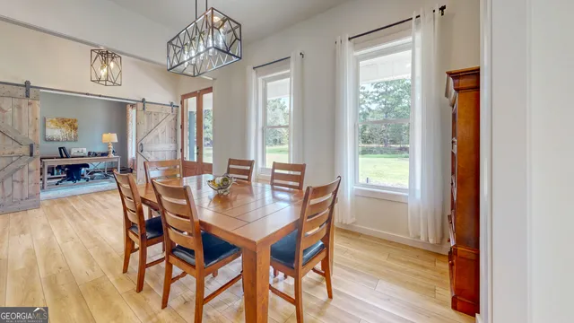 a view of a dining room with furniture window and wooden floor