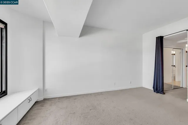 a bathroom with a glass shower door and a mirror