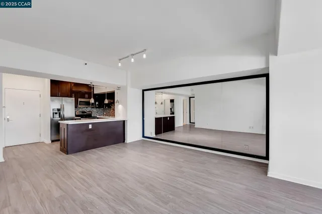 a view of empty room with wooden floor