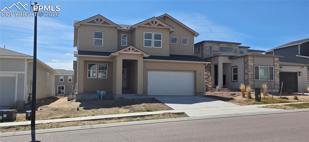View of front of home featuring driveway and an attached garage