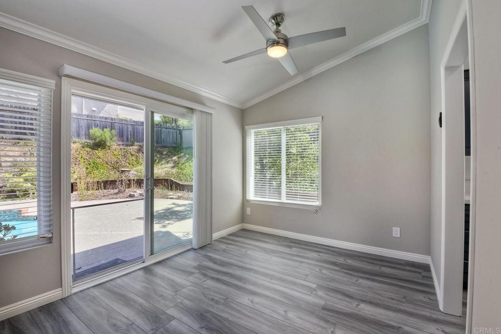 6428 El Perico Lane Carlsbad, CA 92009 - Photo 14 of 35 an empty room with wooden floor and windows