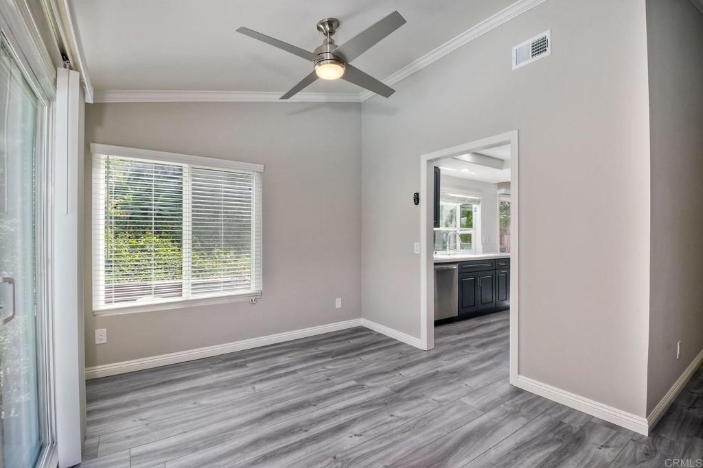 6428 El Perico Lane Carlsbad, CA 92009 - Photo 15 of 35 a view of an empty room with a window and wooden floor