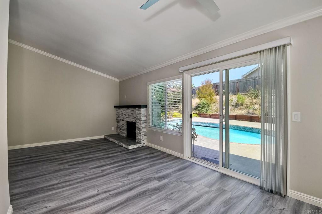 6428 El Perico Lane Carlsbad, CA 92009 - Photo 16 of 35 a view of empty room with wooden floor and floor to ceiling window
