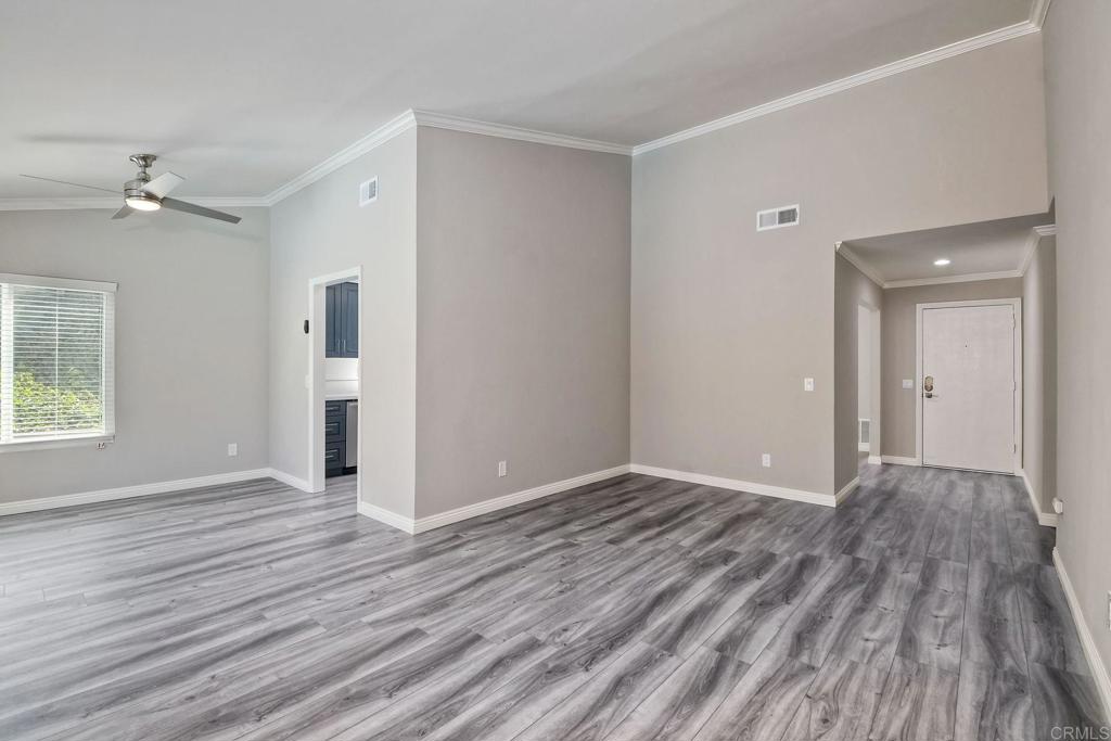 6428 El Perico Lane Carlsbad, CA 92009 - Photo 19 of 35 a view of an empty room with wooden floor and a window