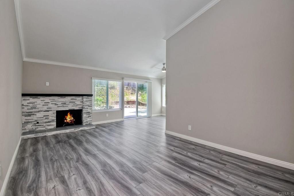 6428 El Perico Lane Carlsbad, CA 92009 - Photo 20 of 35 a view of a livingroom with wooden floor and a fireplace