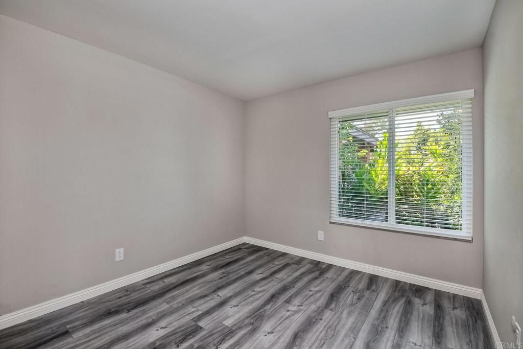 6428 El Perico Lane Carlsbad, CA 92009 - Photo 22 of 35 a view of an empty room with wooden floor and a window