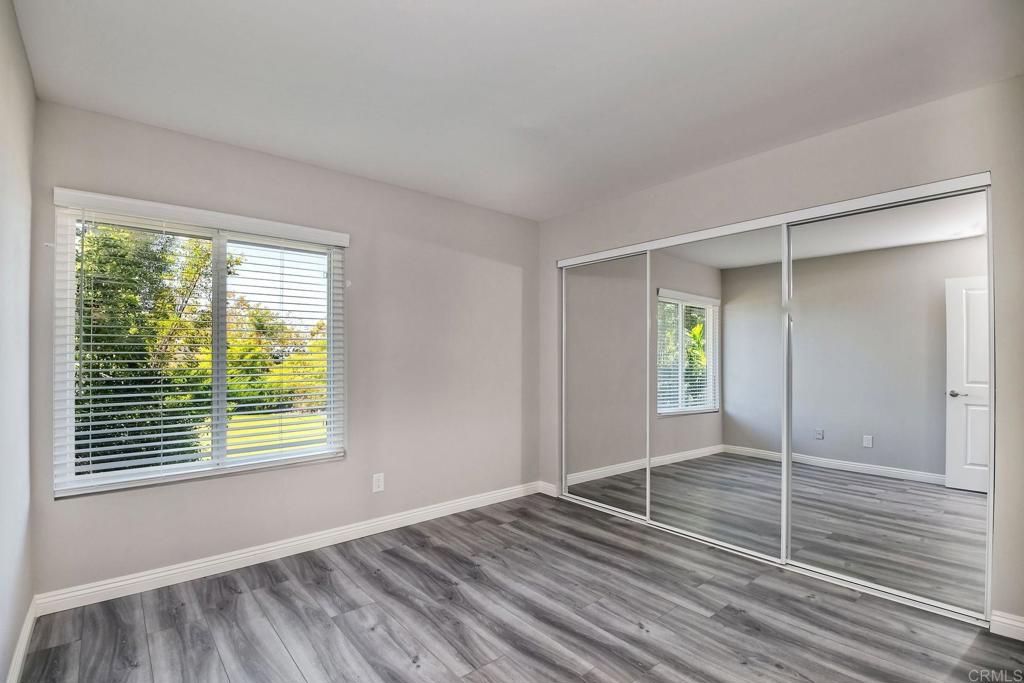 6428 El Perico Lane Carlsbad, CA 92009 - Photo 23 of 35 a view of an empty room with wooden floor and a window