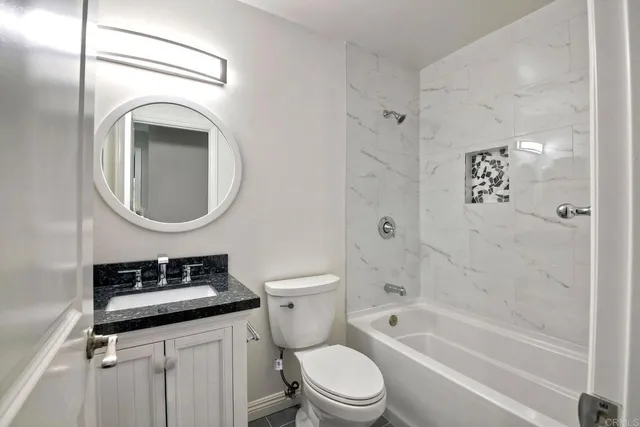 a bathroom with a toilet a sink and a mirror