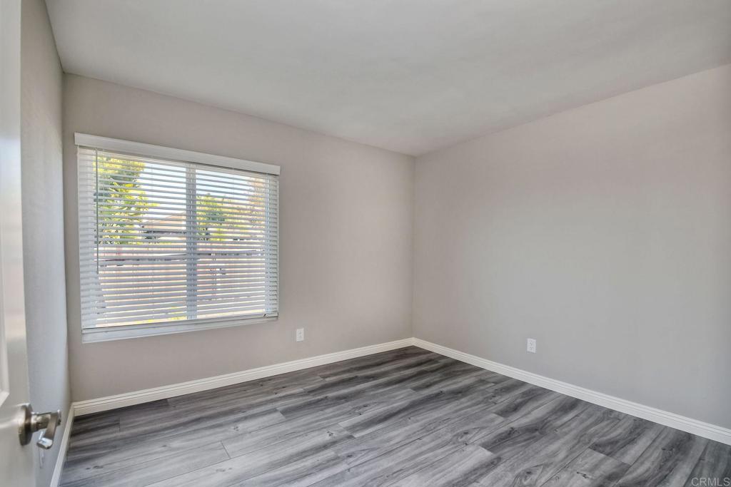 6428 El Perico Lane Carlsbad, CA 92009 - Photo 25 of 35 a view of an empty room with wooden floor and a window