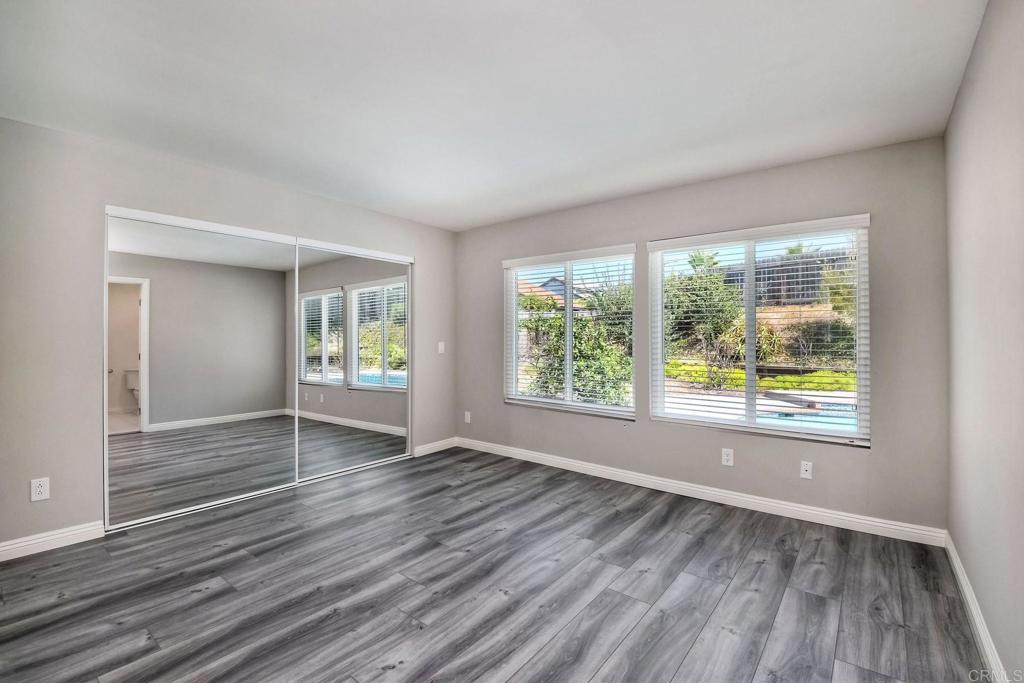 6428 El Perico Lane Carlsbad, CA 92009 - Photo 26 of 35 a view of an empty room with wooden floor and a window