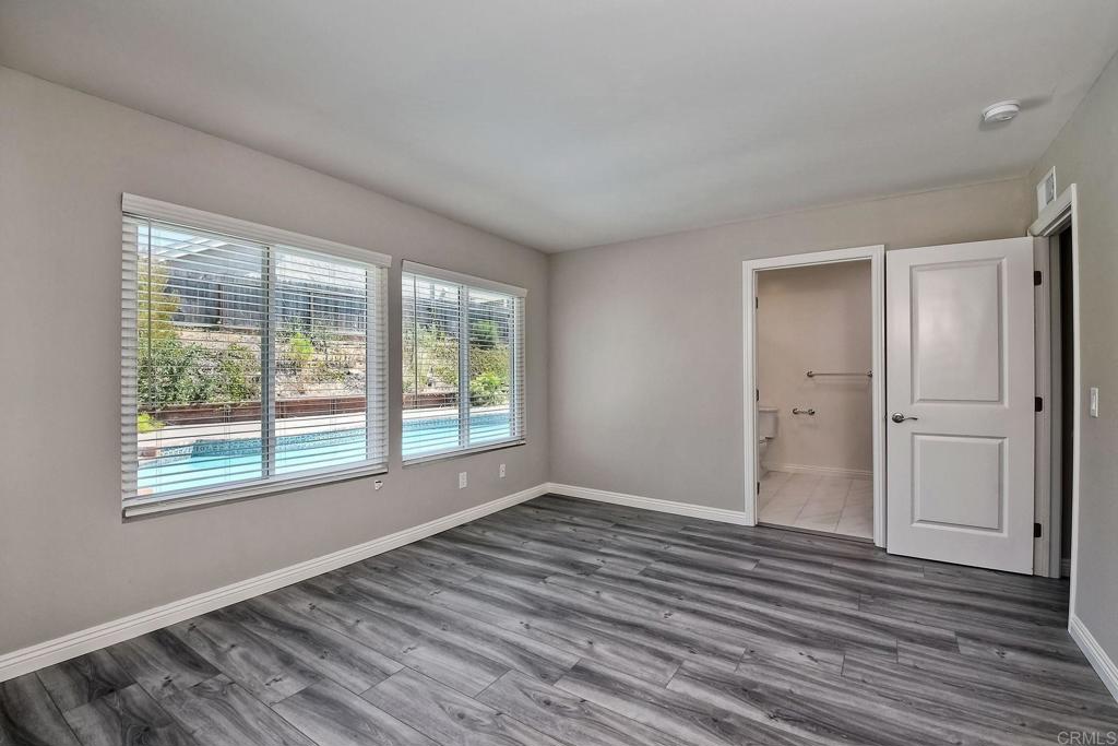 6428 El Perico Lane Carlsbad, CA 92009 - Photo 27 of 35 a view of an empty room with wooden floor and a window