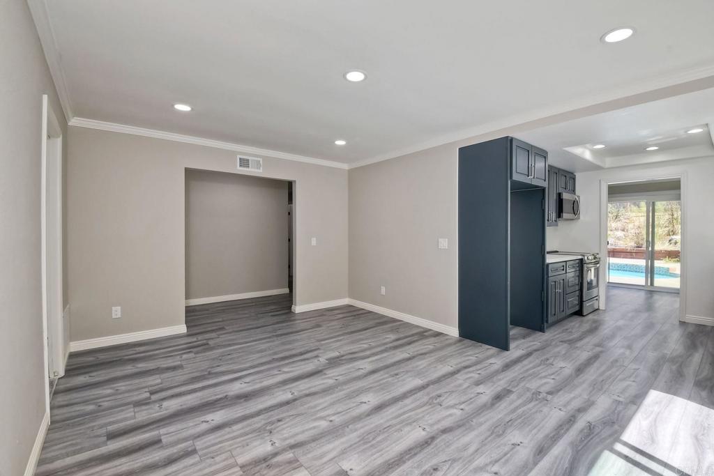 6428 El Perico Lane Carlsbad, CA 92009 - Photo 9 of 35 a view of an empty room with wooden floor and a window