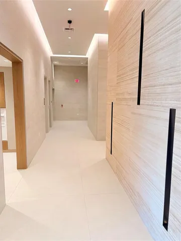 a bedroom with furniture and a large window