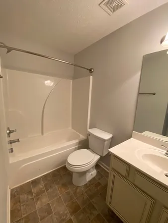 a bathroom with a sink a toilet and a bathtub