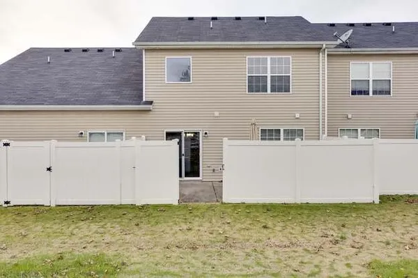 a view of a house with a backyard