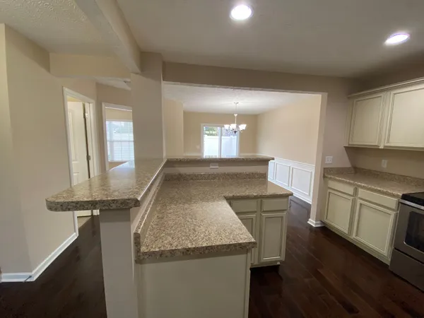 a kitchen with granite countertop a sink and cabinets