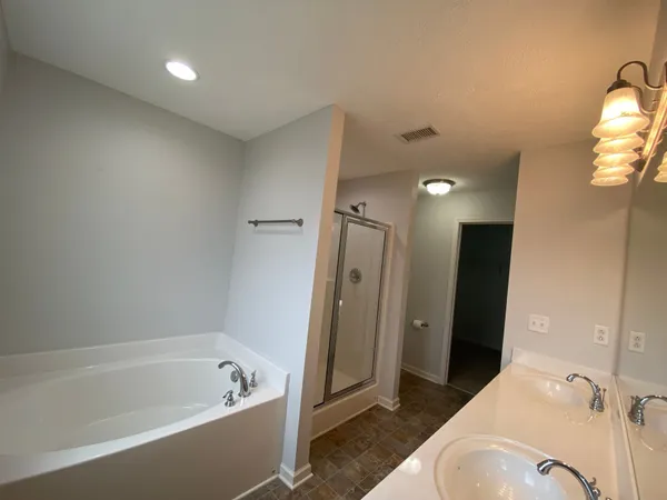 a bathroom with a bathtub and a sink