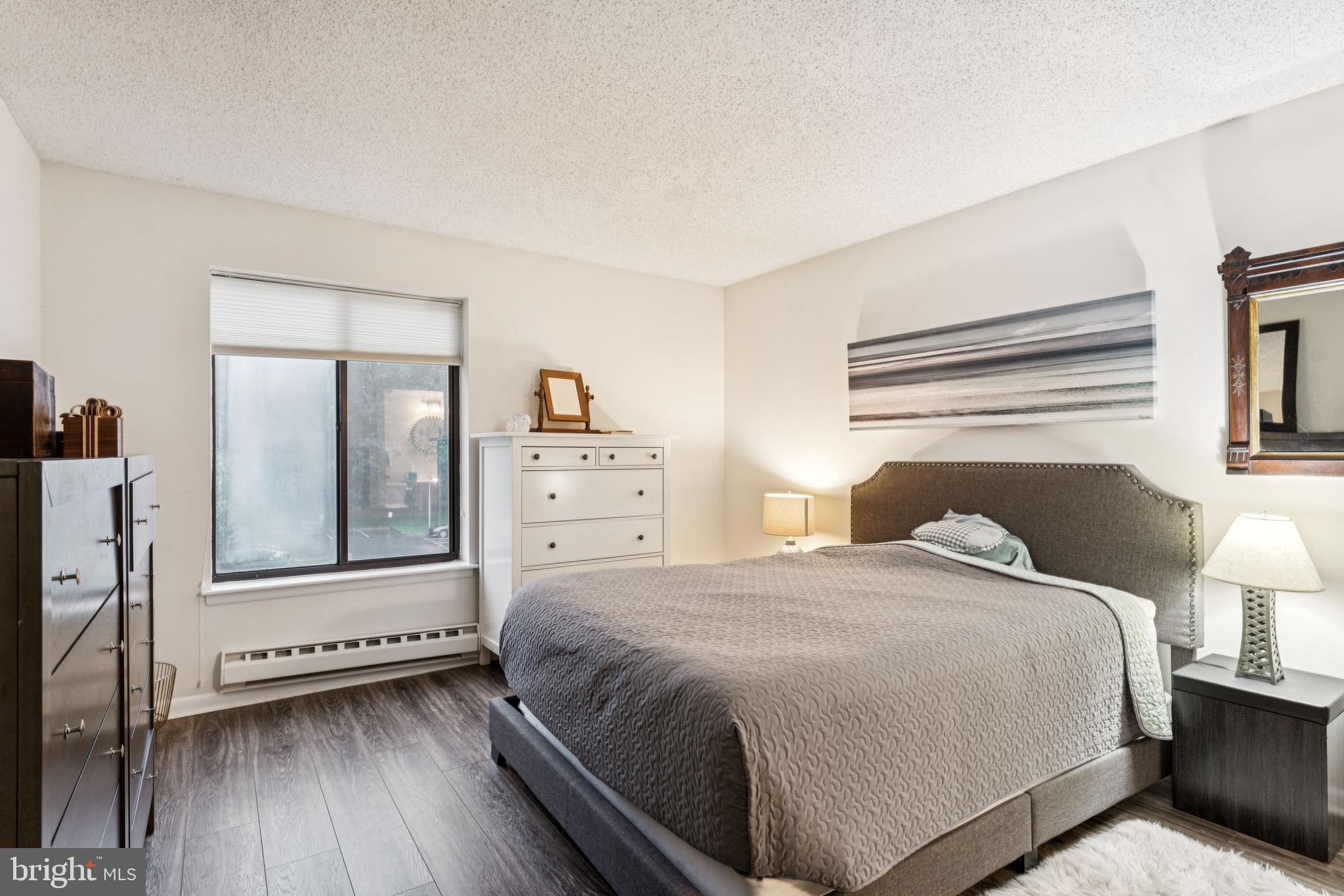 15301 Beaverbrook Court, Unit 923K Silver Spring, MD 20906 - Photo 15 of 25 a bedroom with a bed and a lamp