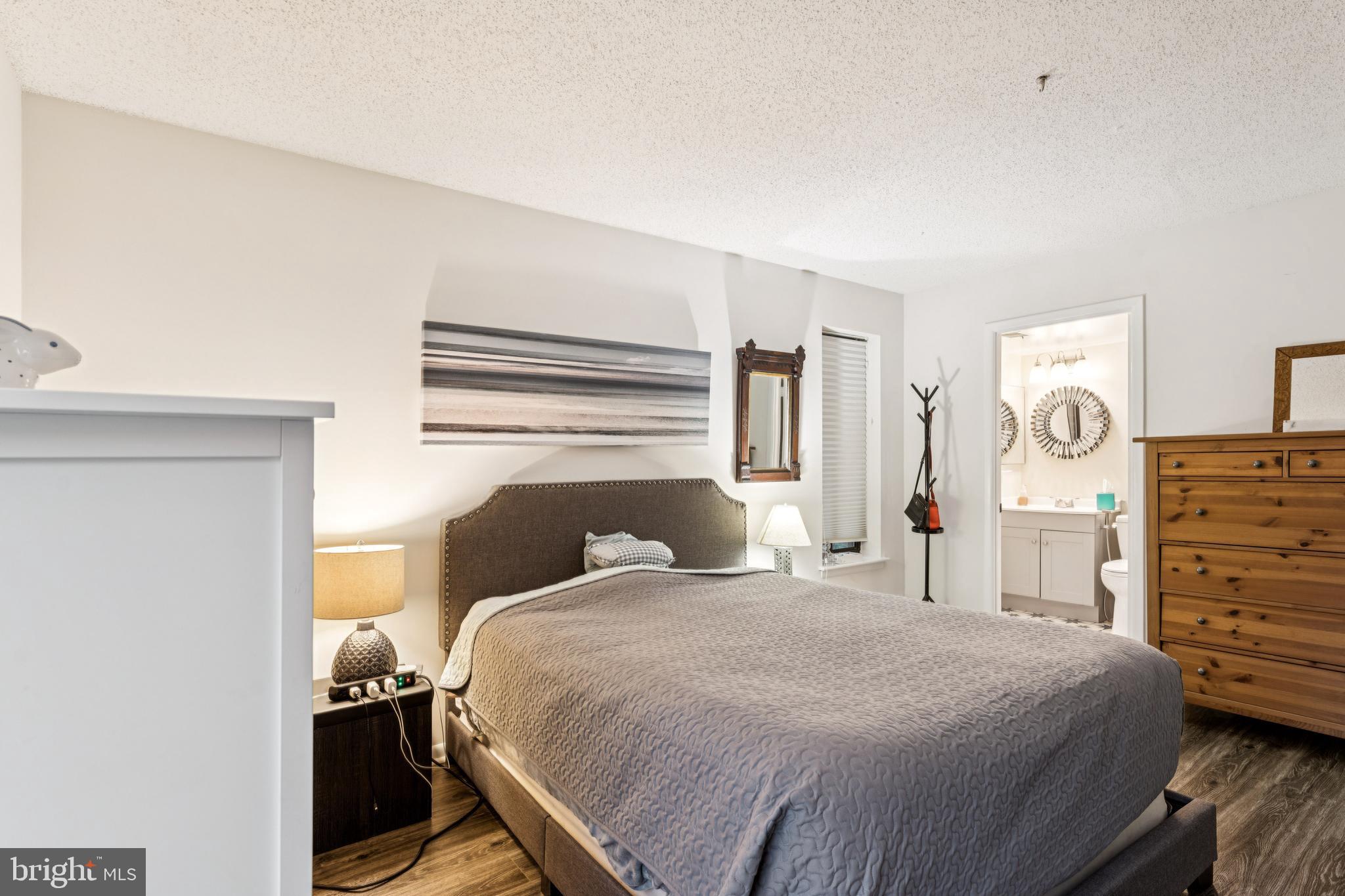 15301 Beaverbrook Court, Unit 923K Silver Spring, MD 20906 - Photo 16 of 25 a bedroom with a bed and dresser