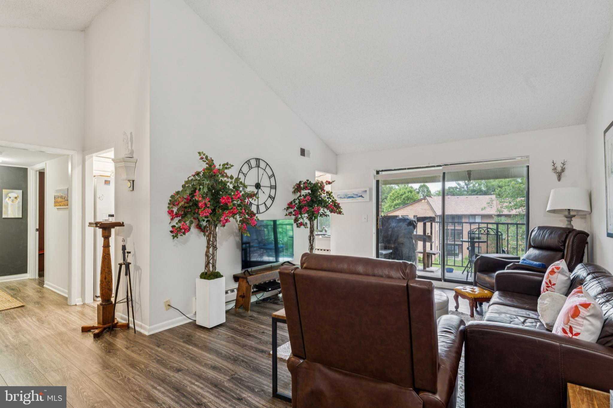 15301 Beaverbrook Court, Unit 923K Silver Spring, MD 20906 - Photo 2 of 25 a living room with furniture and a floor to ceiling window