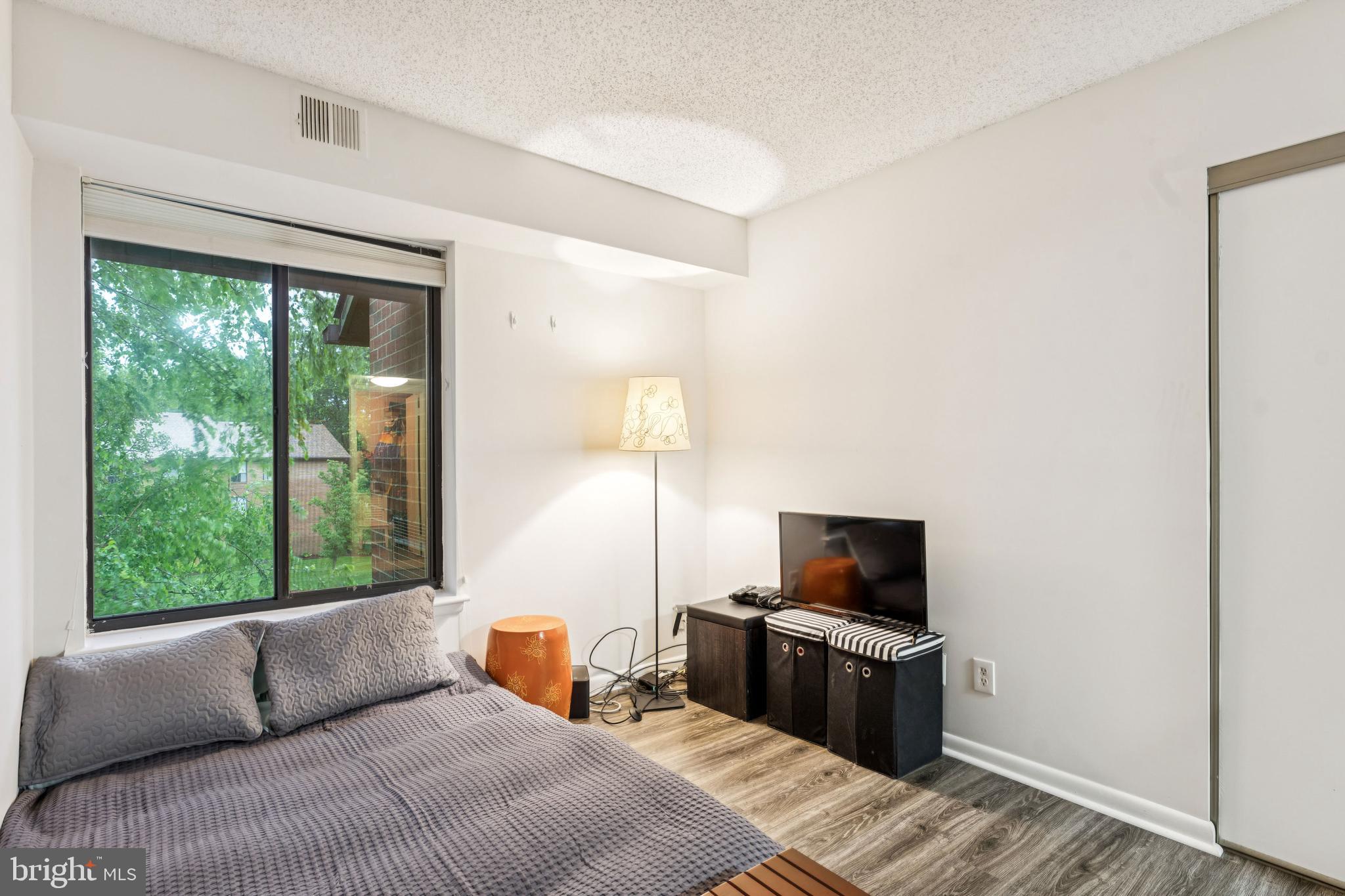 15301 Beaverbrook Court, Unit 923K Silver Spring, MD 20906 - Photo 20 of 25 a bedroom with a bed and a television