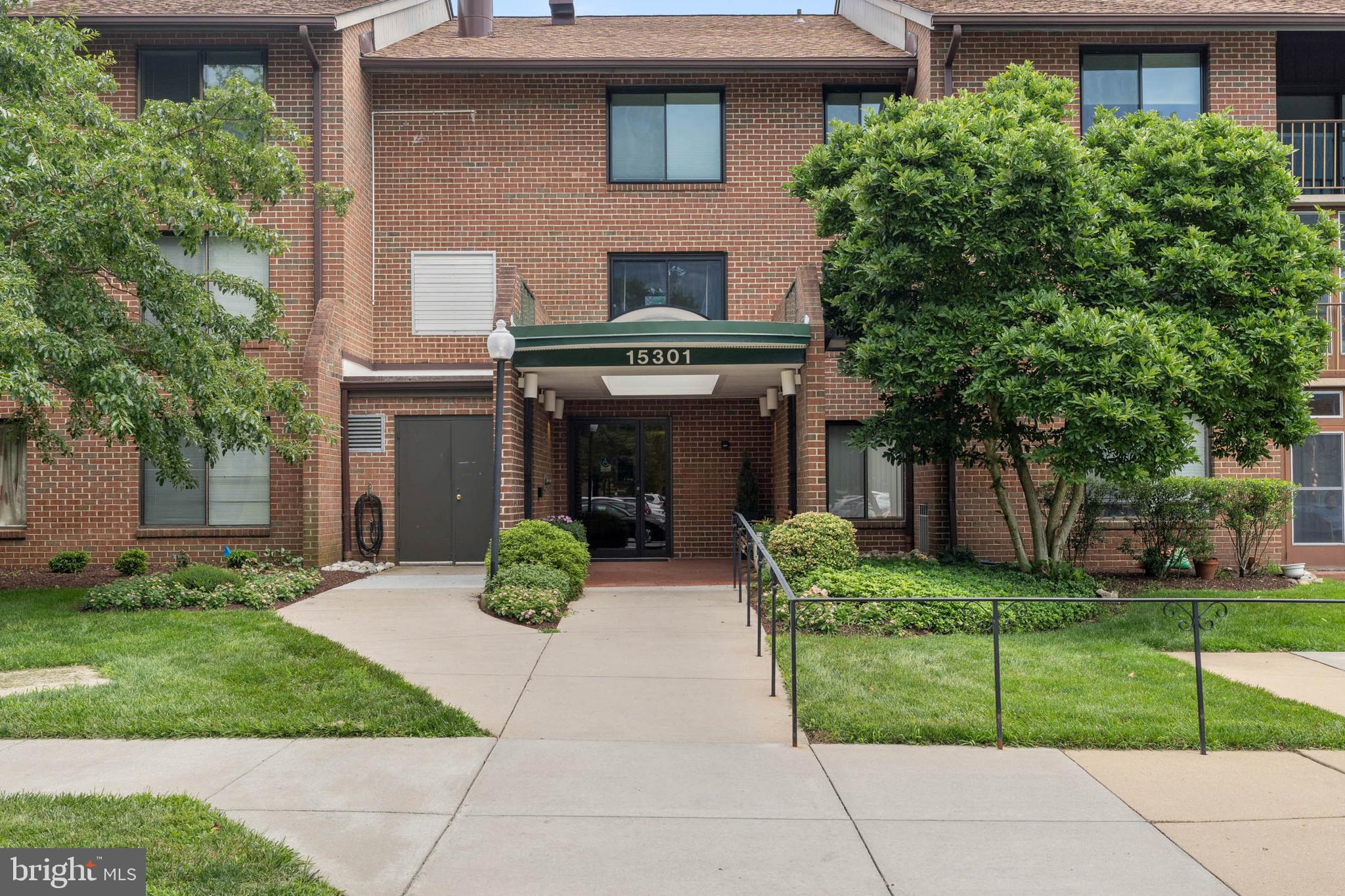 15301 Beaverbrook Court, Unit 923K Silver Spring, MD 20906 - Photo 22 of 25 front view of a house with a yard