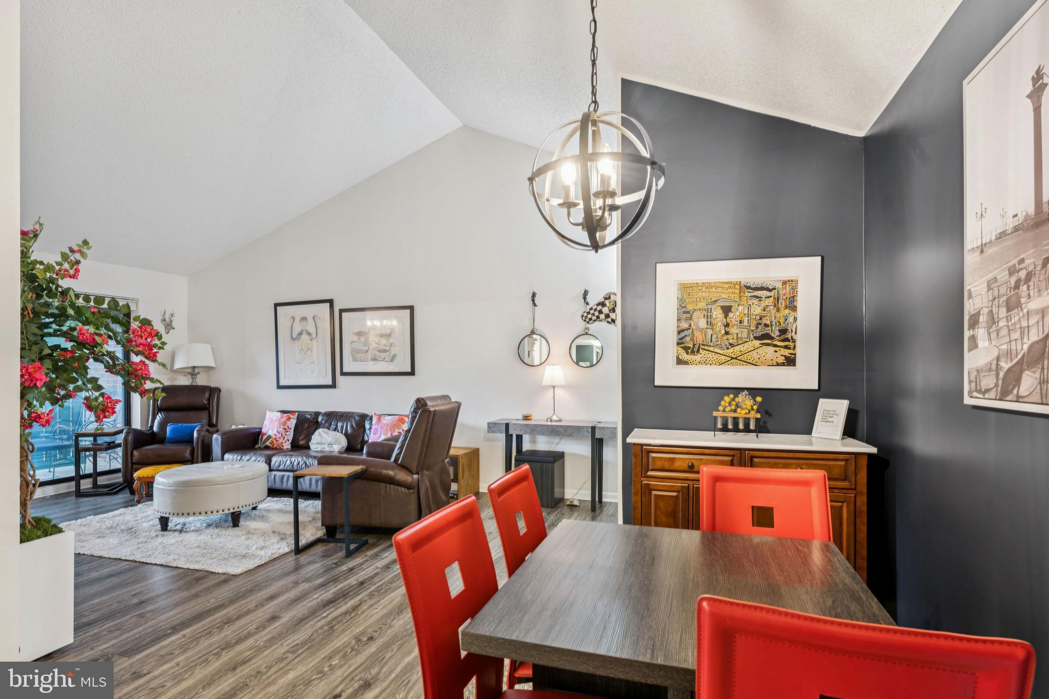 15301 Beaverbrook Court, Unit 923K Silver Spring, MD 20906 - Photo 25 of 25 a view of a dining room with furniture a chandelier and wooden floor