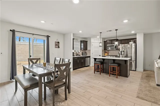 a view of a dining room with furniture and a kitchen
