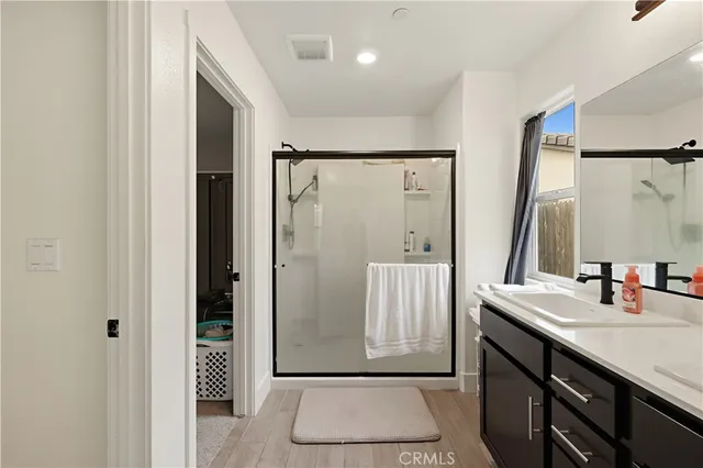 a bathroom with a sink a mirror and a shower