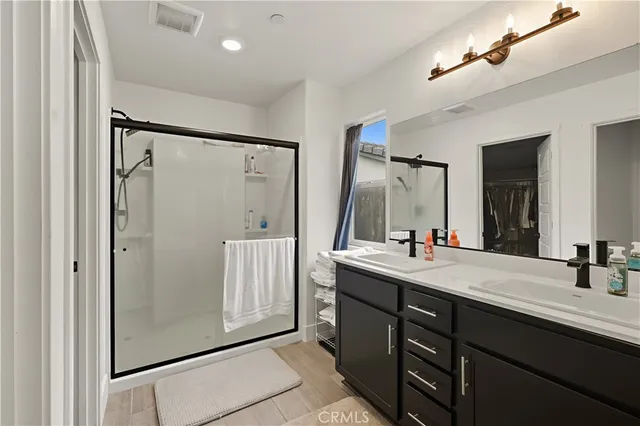 a bathroom with a double vanity sink mirror and double