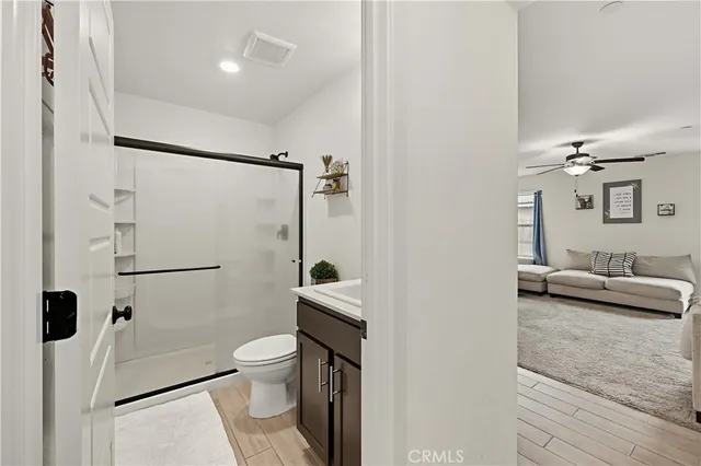 a bathroom with a sink toilet a mirror and shower