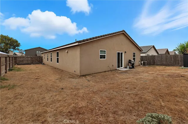 a backyard of a house with table and chairs