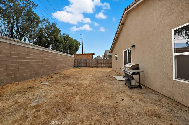 a view of backyard with wooden fence