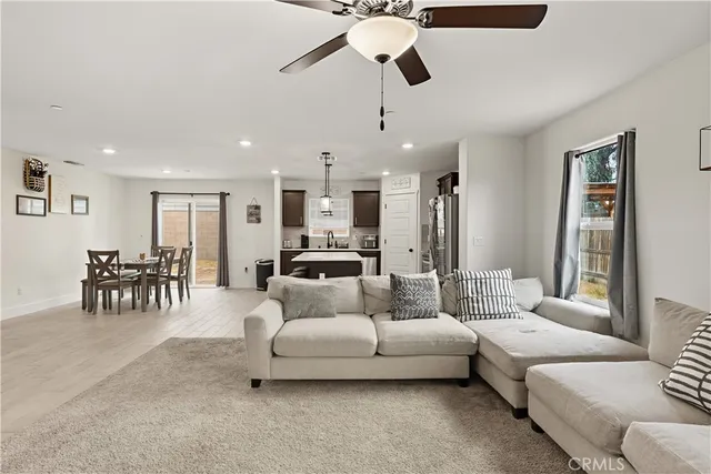 a living room with furniture and a chandelier