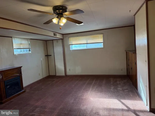 a view of an empty room with a ceiling fan