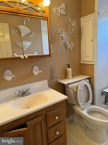 a bathroom with a toilet sink and mirror
