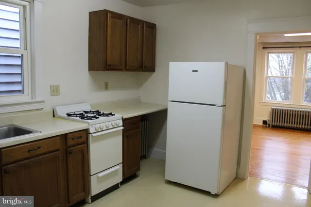 a kitchen with a refrigerator sink stove and cabinets