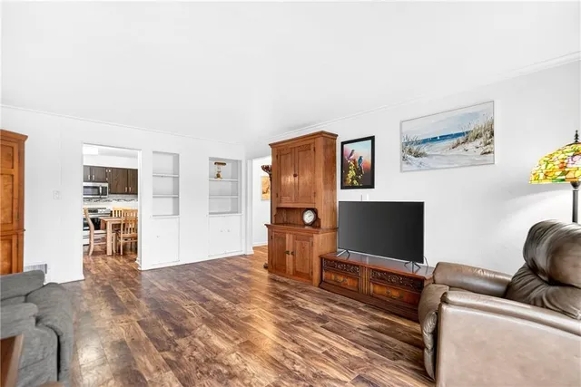 a kitchen with stainless steel appliances granite countertop a sink dishwasher a stove top oven a refrigerator with island and chairs