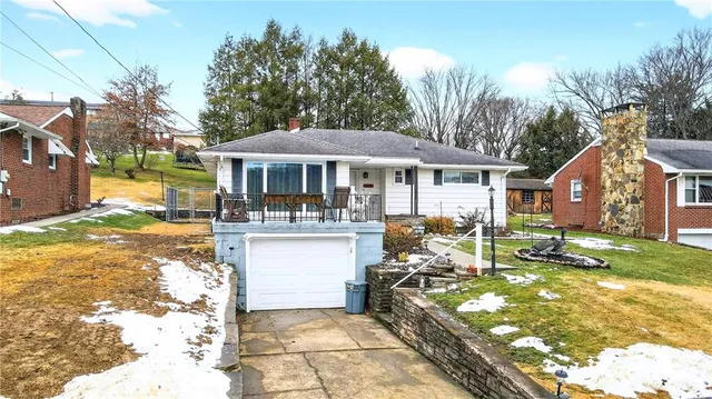 a front view of a house with a yard patio and fire pit