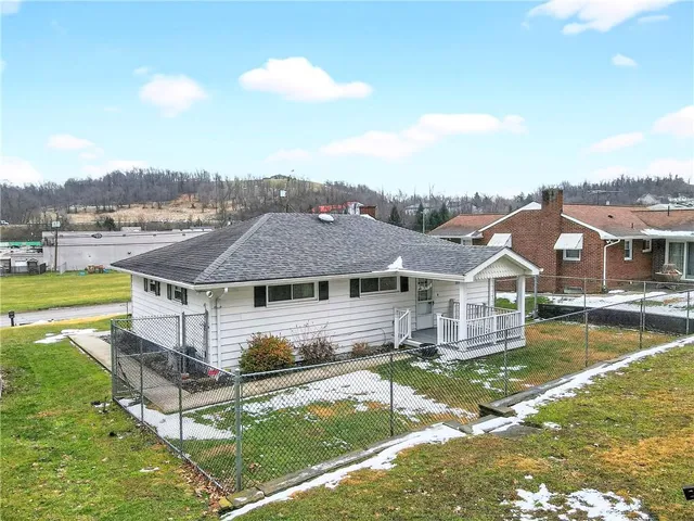a aerial view of a house with swimming pool and a yard