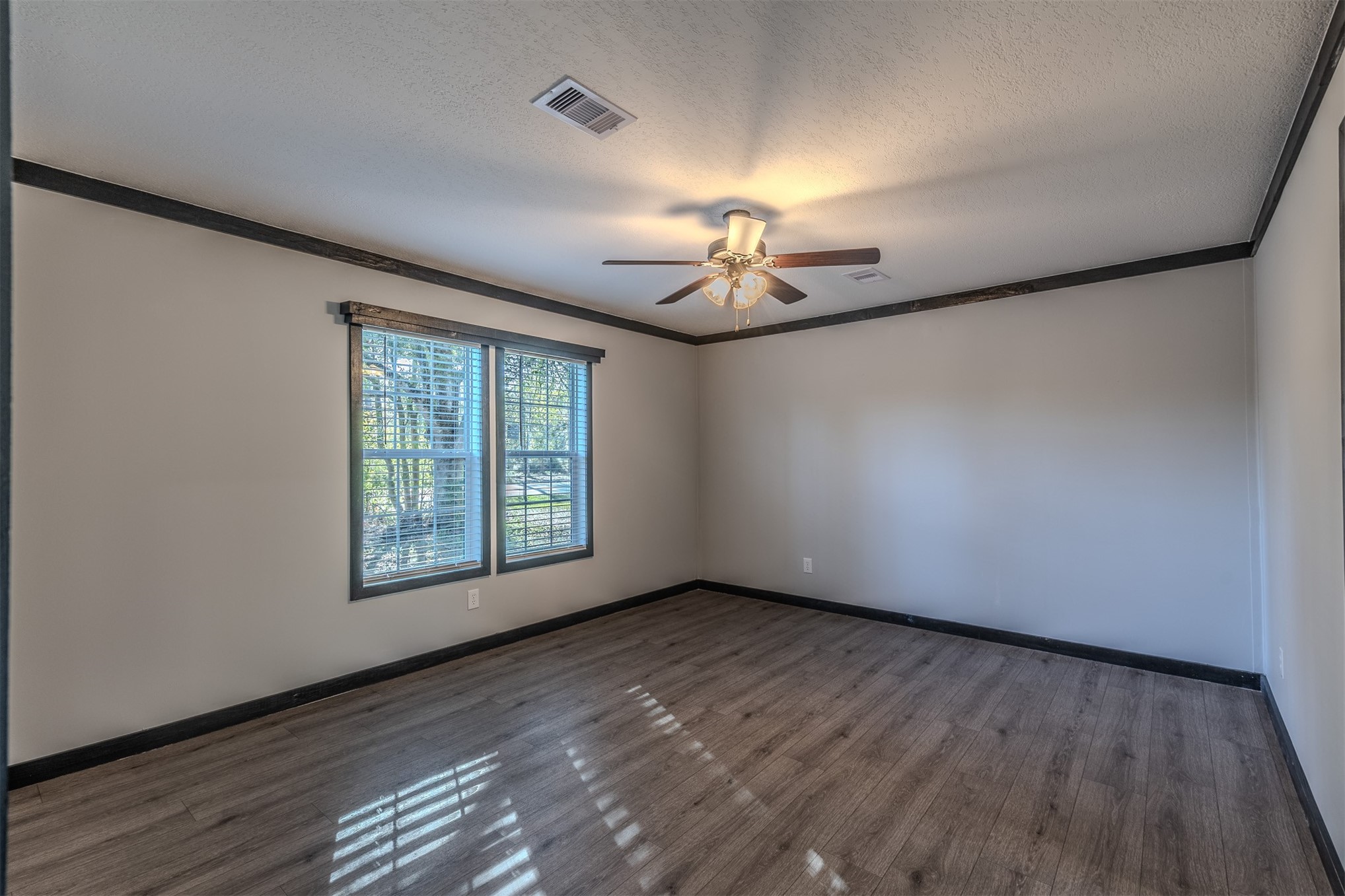 541746 Lem Turner Road Callahan, FL 32011 - Photo 11 of 25 a view of an empty room with a window and wooden floor