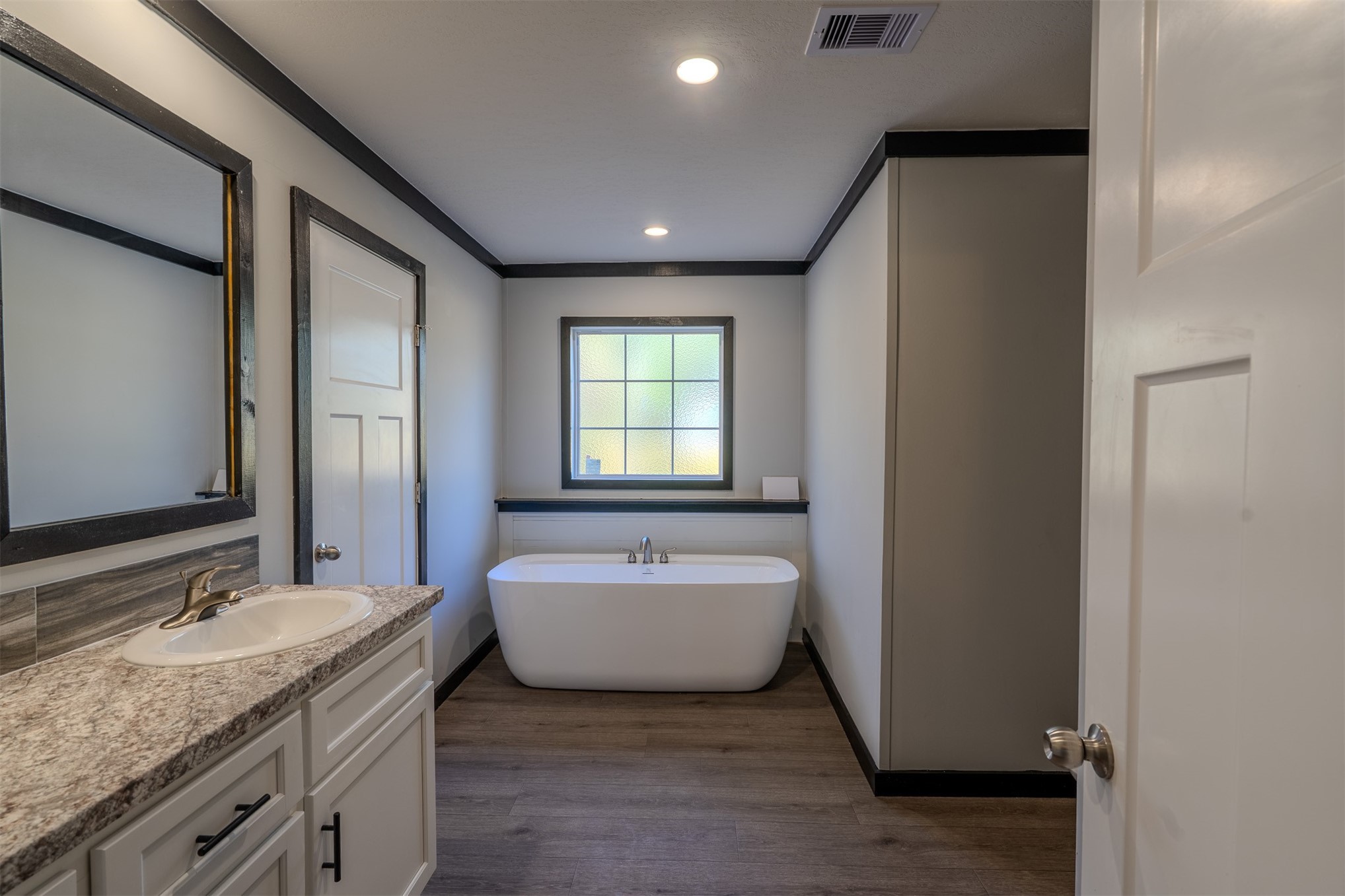 541746 Lem Turner Road Callahan, FL 32011 - Photo 13 of 25 a spacious bathroom with a granite countertop tub sink and mirror
