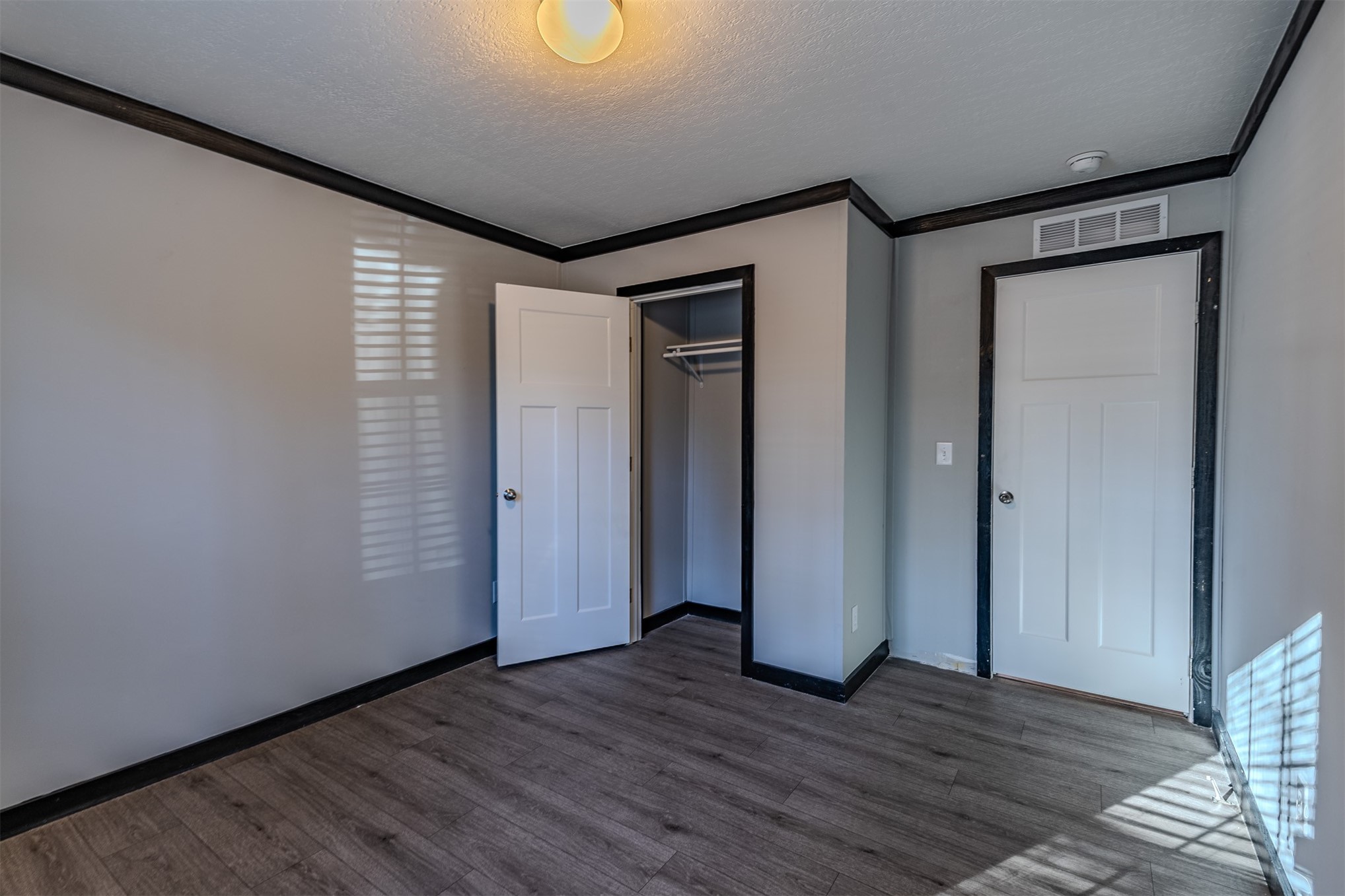 541746 Lem Turner Road Callahan, FL 32011 - Photo 18 of 25 a view of an empty room with wooden floor and a window