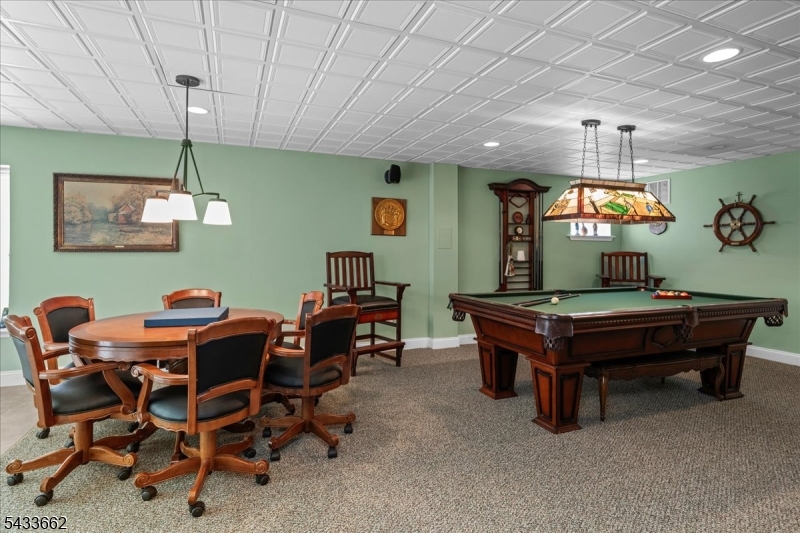 15 Bracken Hill Road Hamburg, NJ 07419 - Photo 31 of 44 a room with furniture a chandelier and a projector