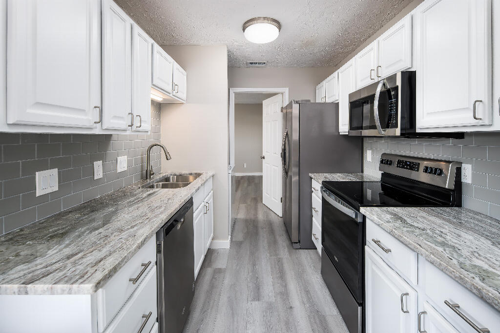 64 Cross Creek Road, Unit 20 Miramar Beach, FL 32550 - Photo 11 of 19 a kitchen with stainless steel appliances granite countertop a stove a sink and a microwave