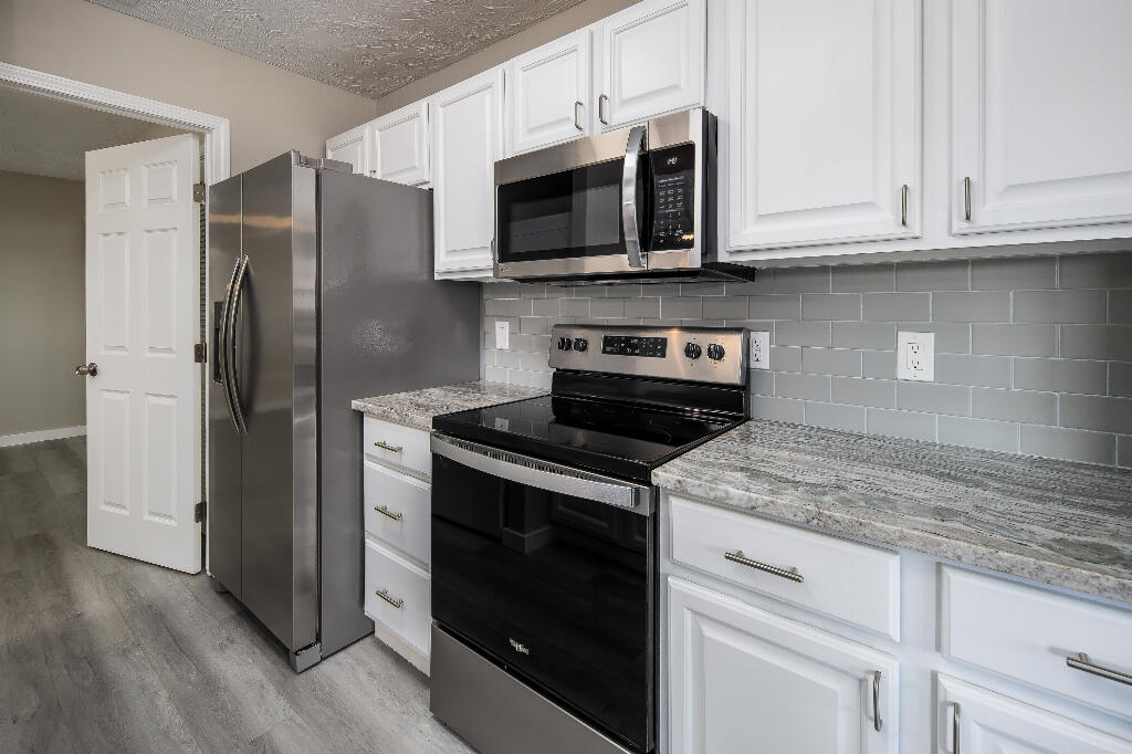 64 Cross Creek Road, Unit 20 Miramar Beach, FL 32550 - Photo 13 of 19 a kitchen with stainless steel appliances granite countertop a refrigerator stove and microwave