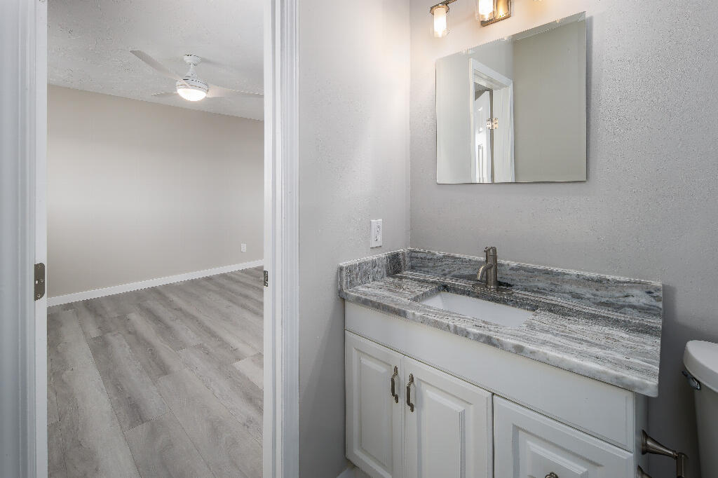 64 Cross Creek Road, Unit 20 Miramar Beach, FL 32550 - Photo 17 of 19 a bathroom with a granite countertop sink and a mirror