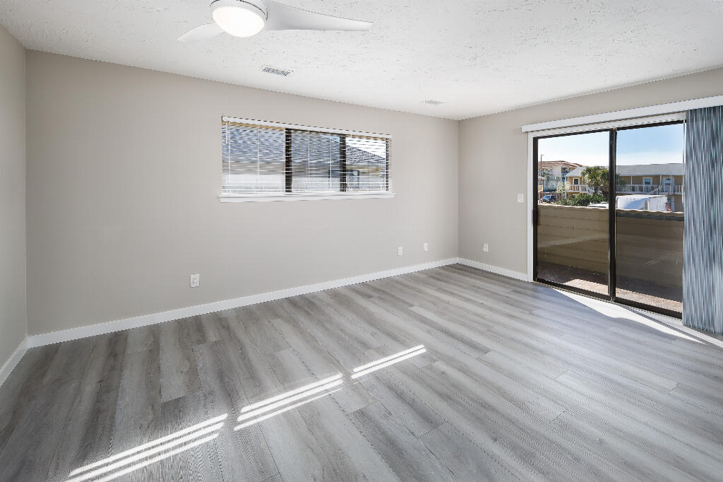 64 Cross Creek Road, Unit 20 Miramar Beach, FL 32550 - Photo 10 of 19 a view of an empty room with wooden floor and a window